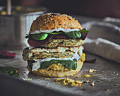 Veggie burger with zucchini patties, corn puree and yoghurt sauce