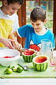 Kids preparing watermelon lemonade