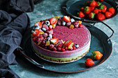 Vegan raw cheesecake with blueberry, cherry, matcha tea, orange and cashew cream