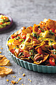 Oven nachos with beans, tomateos and cheese