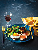 Egg-topped steaks with broccoli and sriracha dressing
