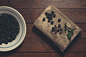 Ripe blackberries garnished by leaves in bowl