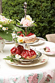 Roses and strawberry cakes on silver cake stand decorating table