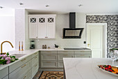 Bright fitted kitchen with L-shaped counter