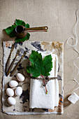 White linen napkin, vine leaves, white eggs, vintage forks and mocha coffee pot