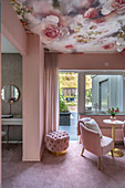 Girl's bedroom decorated in pink with floral wallpaper on ceiling, access to terrace and ensuite bathroom
