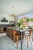Elegant kitchen island with extended counter and bar stools