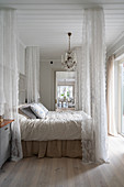 Romantic, Scandinavian-style bedroom with canopy