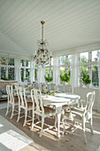 Dining room in antique Swedish style with conservatory windows