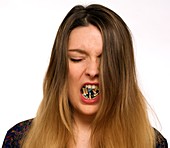Woman with cigarettes in mouth
