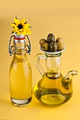 Sunflower plant with a jug of olive oil