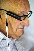 Man using assistive reading device