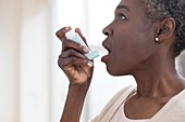Woman using inhaler