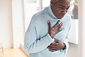 Woman touching chest in pain
