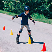 Boy learning to roller skate