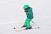 Boy skiing down hill