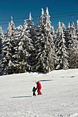 Boy and ski instructor on mountain