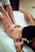 Physical therapist massaging leg
