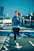 Woman jogging in city at night