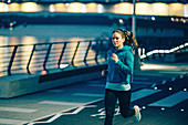 Woman jogging in city at night