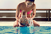 Baby boy and mother in swimming pool