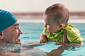 Father with baby boy in the swimming pool
