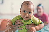 Smiling baby swimming