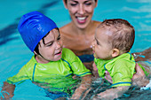 Children in swimming pool with mother