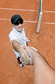 Tennis player shaking hands with chair umpire
