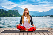 Woman doing yoga by a lake