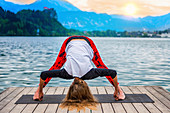 Woman doing yoga by a lake