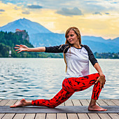 Woman doing yoga by a lake