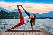 Woman doing yoga by a lake