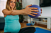 Pregnant woman doing pilates at home