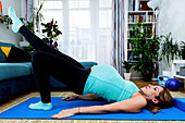 Pregnant woman doing yoga at home