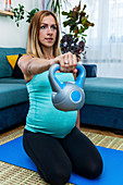 Pregnant woman exercising at home