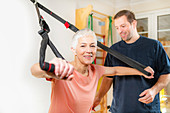 Senior woman with personal trainer