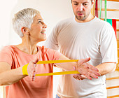 Senior woman exercising with resistance band