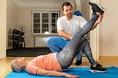 Physical therapist stretching senior woman