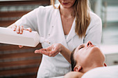 Physical therapist massaging female patient