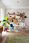 Retro wall-mounted cabinets and collection of chairs around Tulips Table in corner of dining room