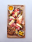 Prosciutto ham and parmesan on cutting-board