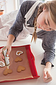 Girl decorating gingerbread cookies
