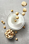 Hazelnuts falling into hazelnut milk