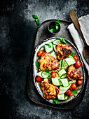 Paprika chicken thighs with cherry tomatoes, courgette ribbons and mint