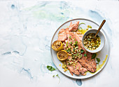 Rainbow trout with spring onion, pine nut and preserved lemon salsa