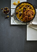 Saffron and sultana millet with spicy baked cauliflower and marinated olives