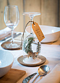 DIY place card with winter landscape under upturned wine glass