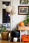 Pleated paper lamps in doorway in vintage-style living room