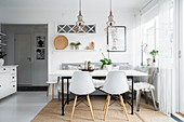 Shell chairs at table in Scandinavian-style dining room